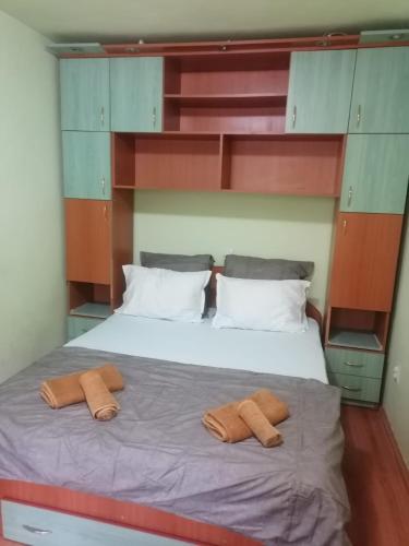 a bedroom with a bed with two pillows on it at Dâmb 2 camere in Târgu-Mureş