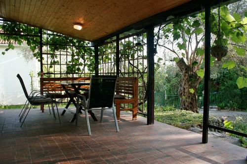 a screened in porch with a table and chairs at Holiday Home Olivia House in Dobra Voda