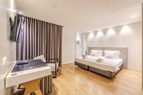 a hotel room with a bed and a sink at Sé INN Studios by House and People in Braga