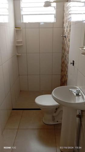 a bathroom with a toilet and a sink and a shower at Casa Prox Centro in Ribeirão Preto