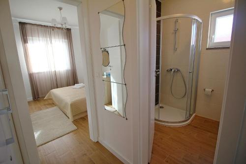 a bathroom with a shower and a walk in shower at Apartments Obitelj Vuletić in Makarska