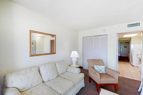 a living room with a couch and a chair at Camelot by the Sea 1506 in Myrtle Beach