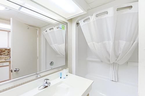 a bathroom with a sink and a mirror at Camelot by the Sea 1506 in Myrtle Beach