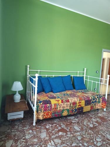 a bedroom with a bed with blue pillows on it at Narniandum Est in Narni