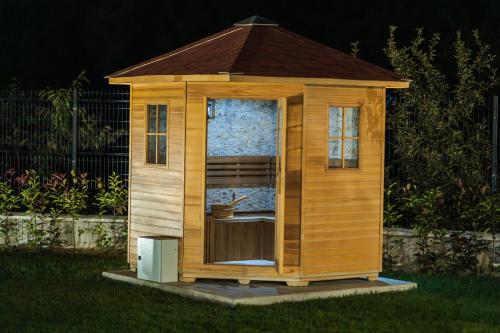a small wooden house in the grass at ENEVI Guest Houses-Къщи за гости Еневи in Sandanski