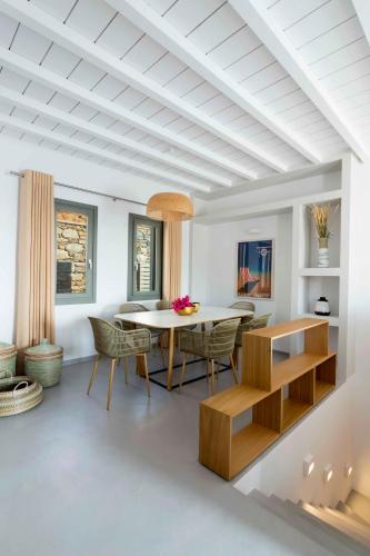 a dining room with a table and chairs at Phos Villas Tinos in Agios Romanos