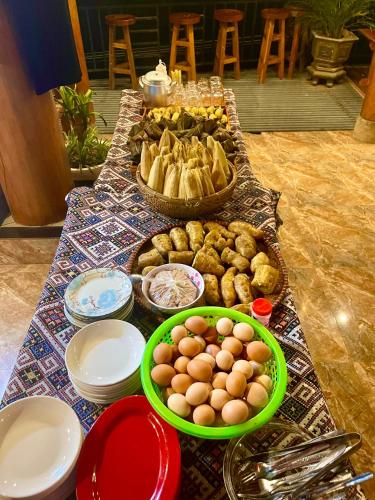 a table with eggs and other food on it at Hiếu Hương Homestay in Lũng Tiềm