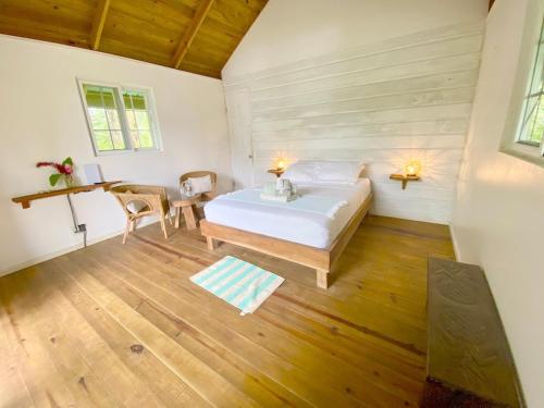 a bedroom with a bed and a table in a room at Bird Island Bungalows in Bocas del Toro