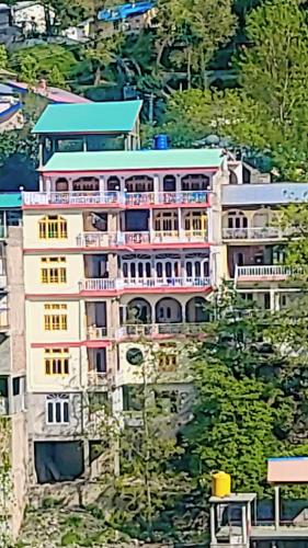a building on the side of a mountain at Hotel Miandam Palace in Mingora