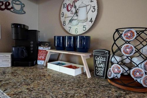 a clock on the wall above a counter with blue cups on a shelf at The Perch at Kimberling Crossing in Kimberling City