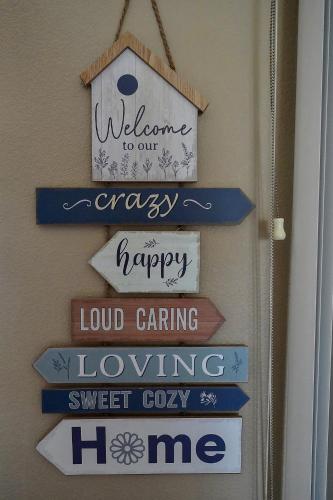 a sign that says welcome to our happy loud caring loving me at The Perch at Kimberling Crossing in Kimberling City