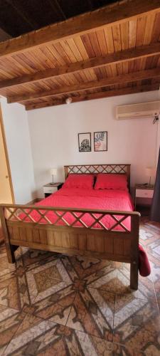 a bedroom with a red bed in a room at Apartamento Del Paseo in Federación