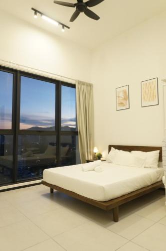 a bedroom with a bed and a large window at Urban Suites Seaview 3Bedrooms 2Carparks 8pax in Jelutong