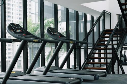a row of treadmills in a building with a staircase at Urban Suites Seaview 3Bedrooms 2Carparks 8pax in Jelutong