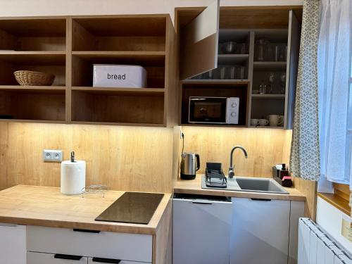a kitchen with a counter top and a sink at Chata 107 Tatralandia Village in Liptovský Mikuláš