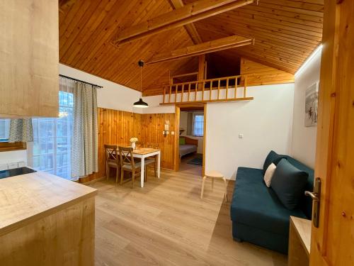 a kitchen and living room with a couch and a table at Chata 107 Tatralandia Village in Liptovský Mikuláš