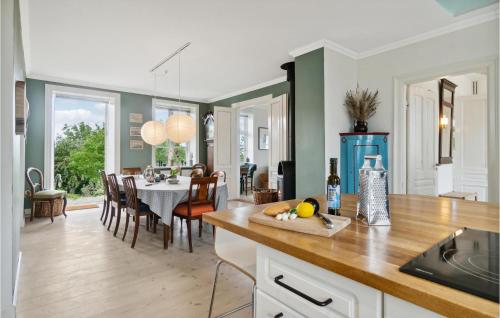 a kitchen and dining room with a dining table at 4 Bedroom Cozy Home In Hasle in Hasle