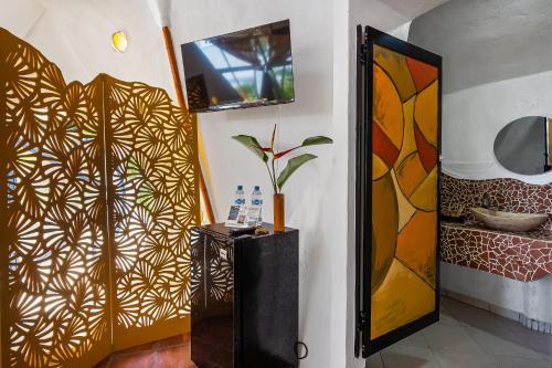 a room with a door with a painting on the wall at Villas Bambu in Barra de Navidad