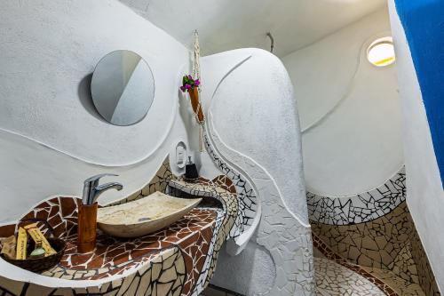 a bathroom with a sink and a mirror at Villas Bambu in Barra de Navidad