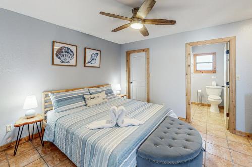a bedroom with a bed and a ceiling fan at The Escape in Seminole