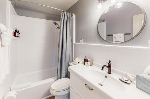 a bathroom with a sink and a toilet and a mirror at The Escape in Seminole