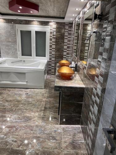 a large bathroom with a tub and a sink at MESAGGALA PALACE No 1 !!! FIRSTLINE SEA in Néa Meságkala