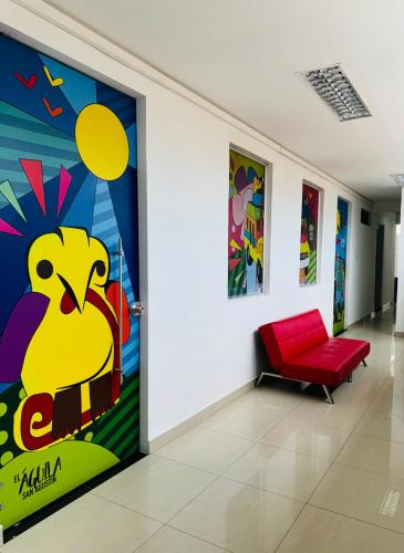a room with a painting of a bird on the wall at Hospedaje Casa Cultural Saberes in Neiva