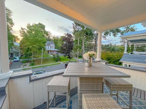 a porch with a table and chairs and a view of a street at The Allen House - 3 Bedroom - 2 Full Bath - Private Gorgeous Apartment - Sleeps 8 in Albany