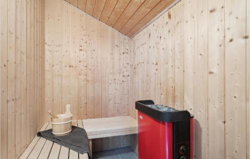 a sauna with a red trash can and a bench at Three-Bedroom Holiday Home In Vinderup in Vinderup