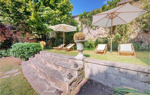 two chairs and umbrellas sitting on a wall at Lovely Home In Villeneuve-Sur-Yonne in Villeneuve-sur-Yonne
