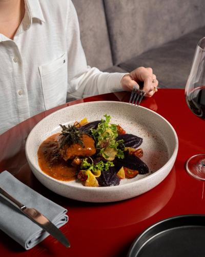 a person sitting at a table with a bowl of food at Pullman Lima Miraflores in Lima