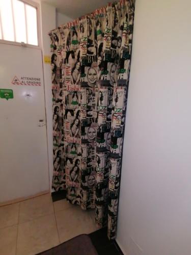 a room with a curtain with faces on a wall at B&B Le Terrazze in Crotone
