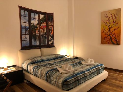 a bedroom with a bed with white shoes on it at Frane House in Lazise