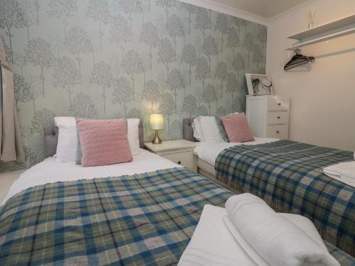 two beds in a small room with two beds sidx sidx sidx at 1 Boarbank Farm in Grange Over Sands