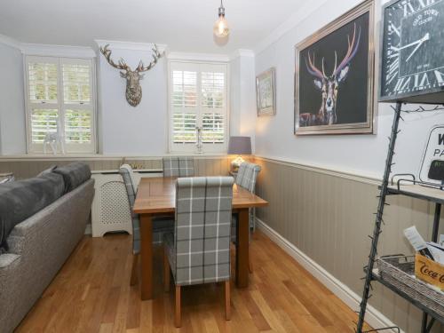 a living room with a table and a couch at 1 Boarbank Farm in Grange Over Sands