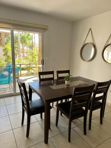 a dining room table with chairs and a mirror at Casa en nuevo Altata, Punta Esmeralda Grand in Altata
