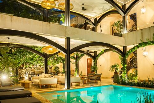 an indoor pool in a building with a ceiling at Adoro Hotel Boutique in Mérida