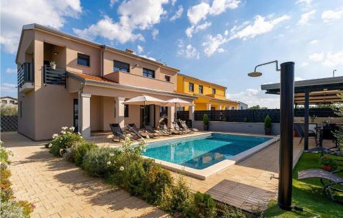 a house with a swimming pool in front of a house at Villa Milina in Višnjan