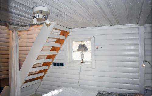a staircase in a white room with a window at Gorgeous Home In Tidaholm With Kitchen in Tidaholm