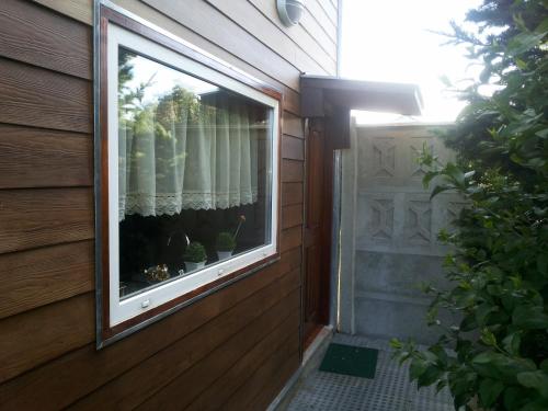 a window on the side of a house at VALYAK rent apart hotel - Servicios Integrales in Punta Arenas
