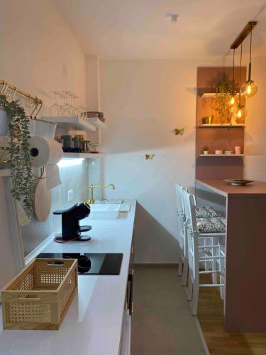 a kitchen with a sink and a counter with chairs at Zlatiborske terase Spa&Wellness in Zlatibor