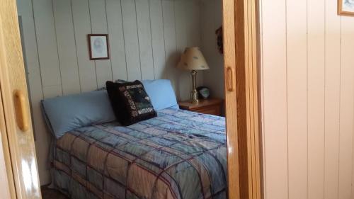 a bedroom with a bed with a pillow on it at Greer Point Trails End Cabins in Greer
