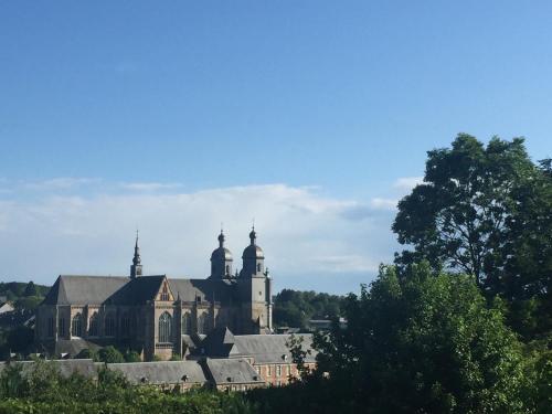 an old church with two domes on top of it at La St Hubsphair in Saint-Hubert