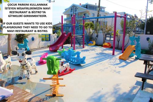 a playground with a slide and play equipment at Mavi Restaurant & Apartments 3 in Didim