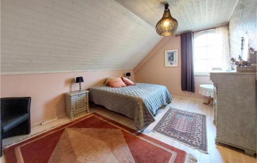 a bedroom with a bed and a tv in a attic at Nice Home In Ljungbyhed With Kitchen in Ljungbyhed