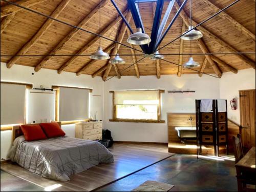 a bedroom with a bed and a desk in it at Capri House in Lago Puelo