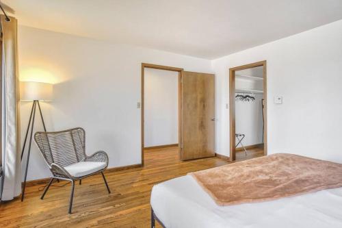 a bedroom with a bed and a chair and a lamp at Private Villa-72 Acres-Hot Tub-Views-USAFA in Colorado Springs