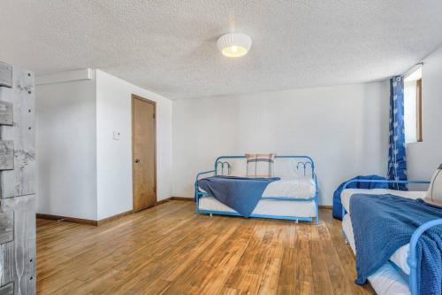a bedroom with two beds and a wooden floor at Private Villa-72 Acres-Hot Tub-Views-USAFA in Colorado Springs