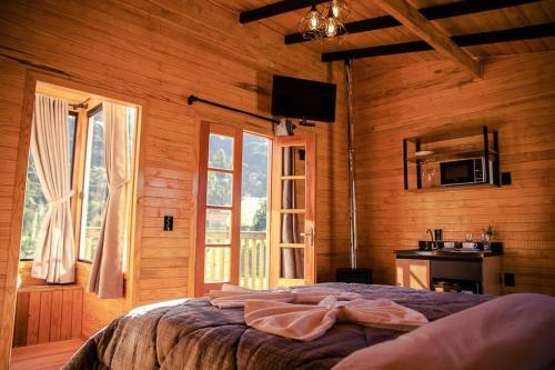 a bedroom with a bed in a wooden room at Blue Sunset in Urubici