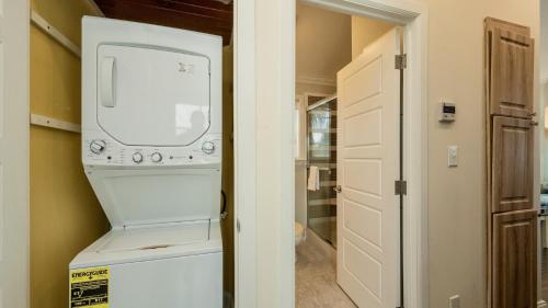 a laundry room with a washer and dryer next to a door at Carefree on Cudjoe by Last Key Realty in Cudjoe Key